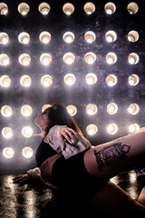Sexy girl dance on front of spot light wall with smoke