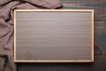 inscription board and napkin on a wooden background top view