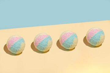 Color bath bombs, isolated on the yellow and blue background, associate summer on the beach