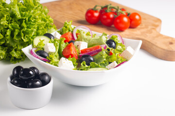Fresh Greek salad with delicious rucola, spinach, arugula, feta cheese, cucumber, red onion and cherry tomato Healthy and diet food concept.