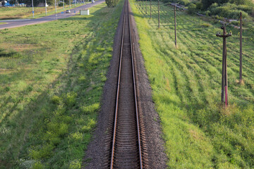 Fototapeta na wymiar railway goes to horizon in green landscape