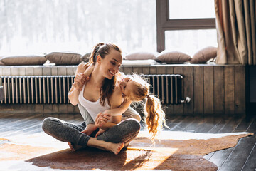 Mother and daughter yoga at home
