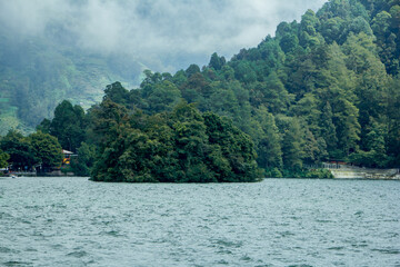 Natural panoramic portrait. Sarangan Lake with fog and boats in the morning.