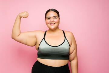 Excited strong woman losing weight with workout exercises
