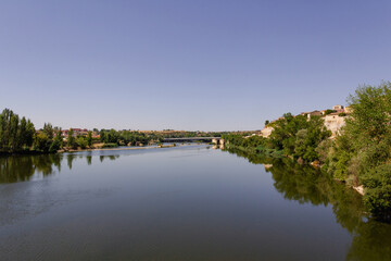 Fototapeta na wymiar The Duero River as it passes through the city of Zamora in Spain. Copy space. Selective focus.