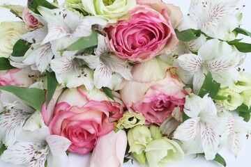 Pink roses and white alstroemeria in an idle bouquet. Solid floral background. Background for a greeting card.