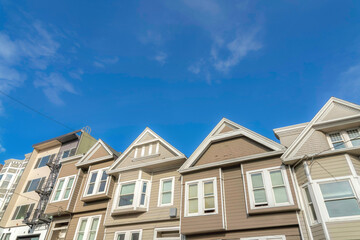 Sloped suburban houses with beige and light brown exterior in San Francisco, California