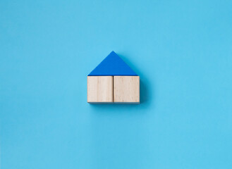 Obraz na płótnie Canvas House out of blocks on a blue background, home concept