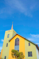 Church exterior with yellow and light green wall exterior in San Francisco, California