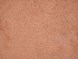 Peach coloured rough wall texture