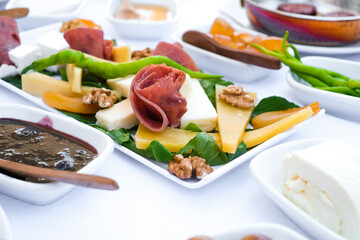 Delicious traditional Turkish breakfast on white table close up