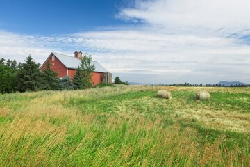 Red barn stands by a field in Idaho.