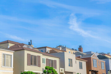 Suburbs houses with different architectural designs and chimneys with flues
