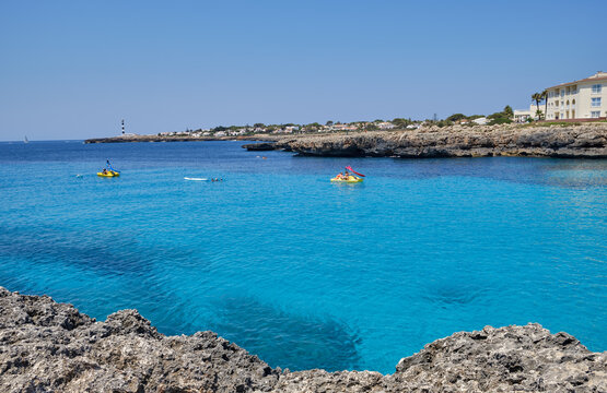 Menorca, Spain: Cala en Bosch beach minorca . Cami de cavalls. Beautiful minorca beach with small hotel in the background. white sand and turquoise water