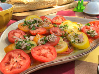 A fantastically tasty dish of French heritage tomato salad served with a crusty baugette