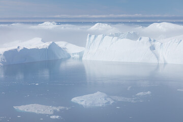 Climate change and global warming. Icebergs from a melting glacier in Ilulissat Glacier, Greenland....