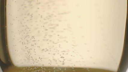 Glass of champagne on white isolated background. Champagne bubbles. Slow motion and super macro shot of tiny air bubbles flowing upwards in elegant glass of champagne on a white background