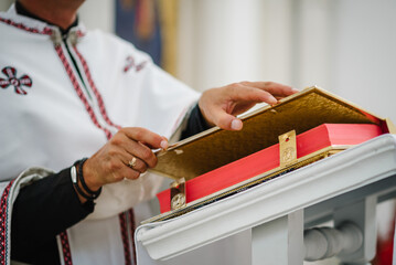Obraz premium The priest reads a bible in the church. Holy sacramental event. Close up.