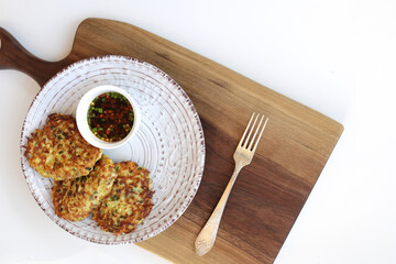 Zucchini fritters, vegetarian zucchini fritters, served with soy dipping sauce. Copy space