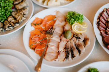 Dish. Red caviar and fish. Tuna. White plate on white table. Food. Fish eggs olives. Holiday food. Wedding day.