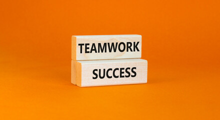 Teamwork success symbol. Concept words Teamwork success on wooden blocks on a beautiful orange table orange background. Business and teamwork success concept. Copy space.