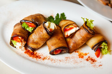 Eggplant rolls with cheese, tomatoes and lettuce