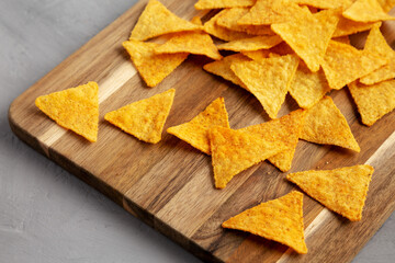 Gluten free Mexican tortilla chips with Barbecue Flavor on a wooden board, side view.