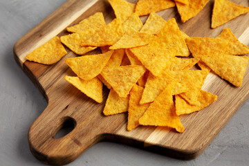 Gluten free Mexican tortilla chips with Barbecue Flavor on a wooden board, side view.