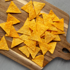 Gluten free Mexican tortilla chips with Barbecue Flavor on a wooden board, top view. Flat lay, overhead, from above.