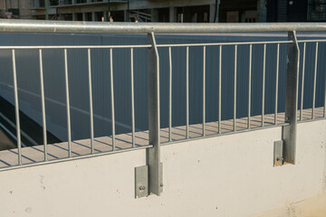 Public furniture: metal balustrade with a metal structure of linear geometry anchored to the wall,...