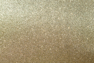 Abstract golden bokeh background, defocused blurry sparkles.
