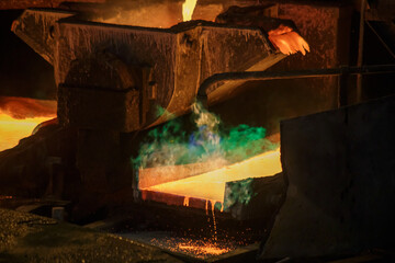 Hot liquid copper pouring into molds.
