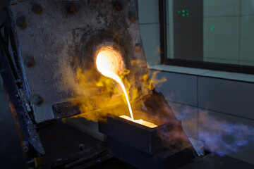 Pouring hot liquid gold into molds.