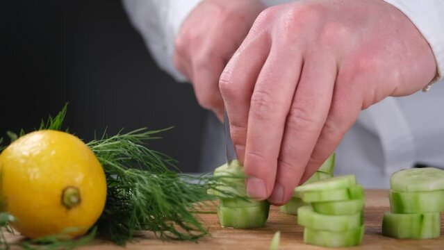 chef cutting cucumber