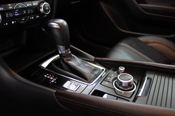 Automatic transmission selector with leather in the interior of a modern expensive car. Luxury car...