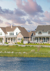 Vertical Puffy clouds at sunset Oquirrh Lake at the front of large residential buildings at Dayb