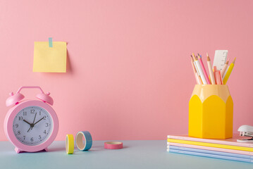 Back to school concept. Photo of school supplies on blue desk pen holder alarm clock stack of...