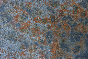 Old cracked painted textured brown background with blue spots.