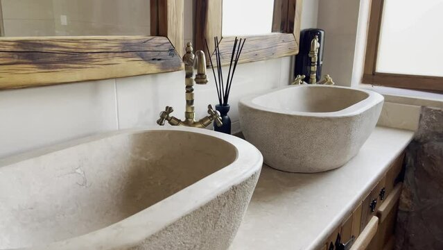 Marble washbasin with antique bronze faucet in the bathroom