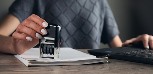 woman hand with stamping documents
