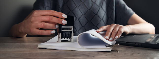 woman hand with stamping documents