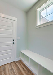 Vertical Mudroom interior with a seating area with shoe storage at the bottom