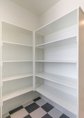 Fototapeta premium Vertical Kitchen pantry interior with built in shelves cabinet