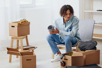 portrait of a man unpacking things from boxes in the room sorting things out