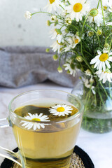Chamomile tea. Herbal tea. Glass cup with warm fragrant chamomile tea