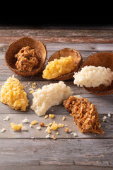 Cocada, Brazilian coconut-based candy arranged on a rustic wooden table, selective focus.