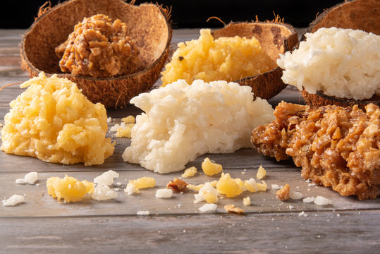 Cocada, Brazilian coconut-based candy arranged on a rustic wooden table, selective focus.
