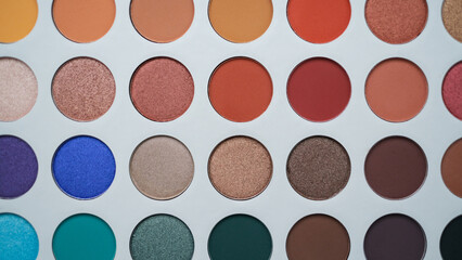 Selective focus of eyeshadow palette with various colors in pearly and matte closeup