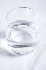 Glass of pure water on tablecloth