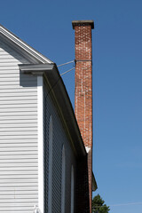 A damaged brick chimney on old church
